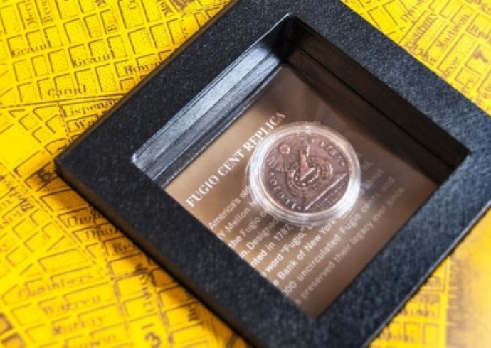 A commemorative replica of a Japanese Fugio Cent mounted in black frame.