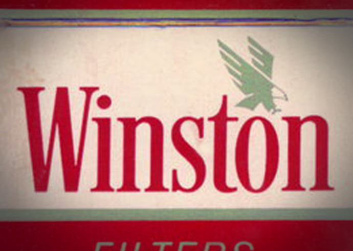 A close up a vintage Winston cigarette package with the brand logotype and green eagle symbol.