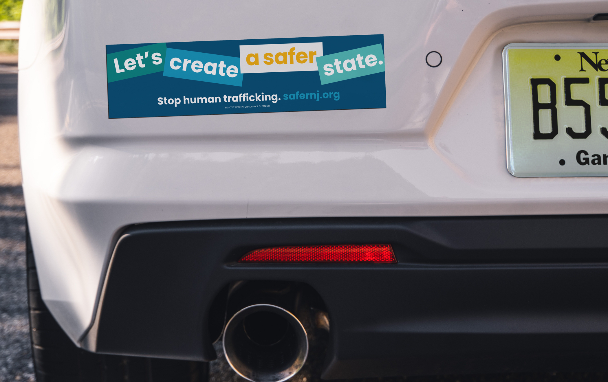 Magnet on car bumper reads “Let’s create a safer state. Stop human trafficking. safernj.org”
