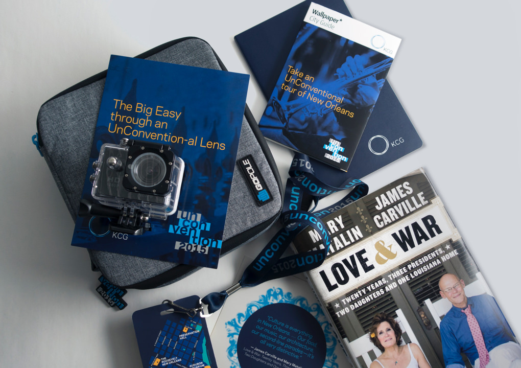 A set of giveaway items for the 2015 KCG Uncon client event, including an underwater camera housing and map of New Orleans.