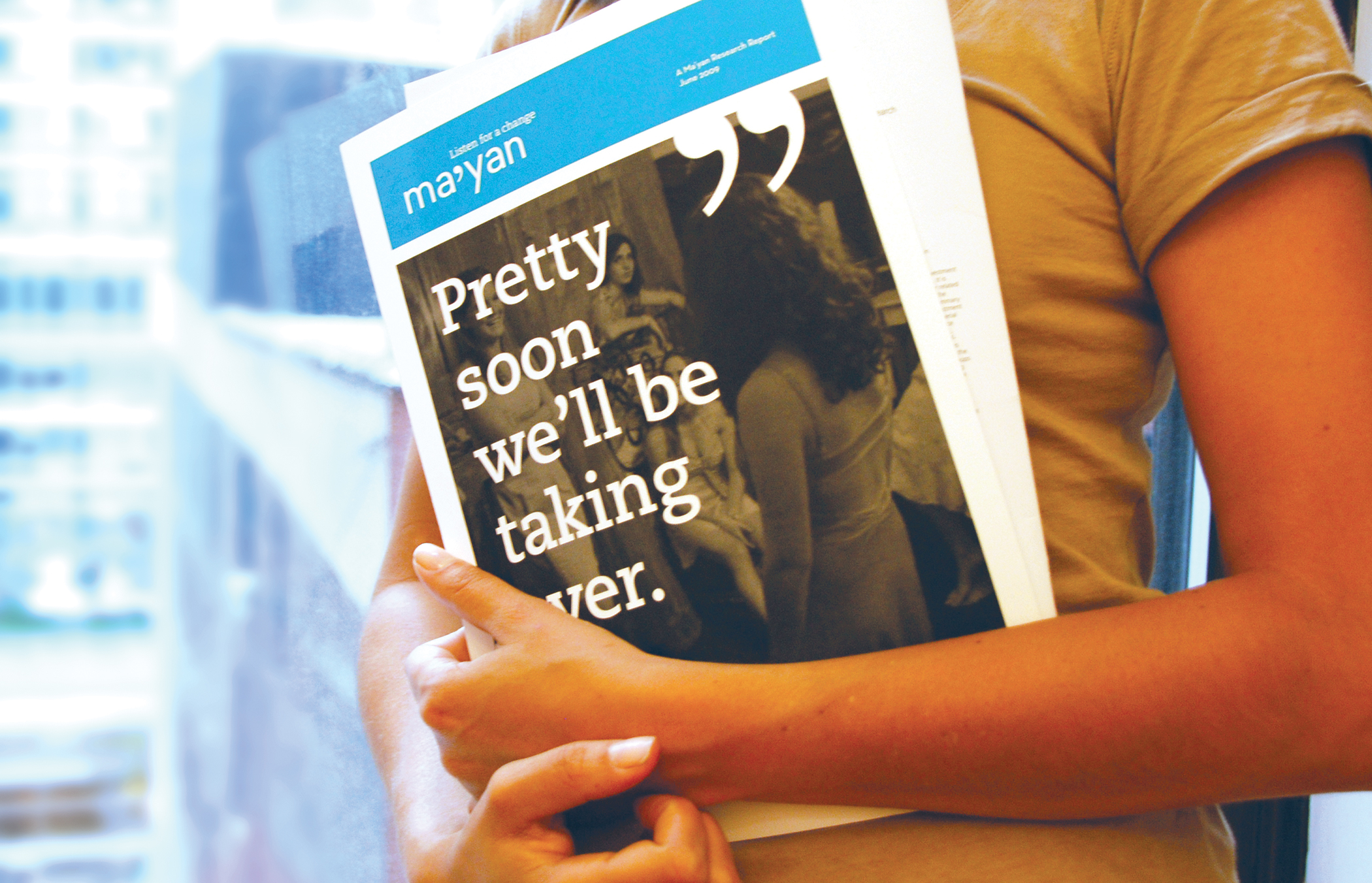 A close up a person carrying a Ma'yan brochure with the title, Pretty soon we'll be taking over.