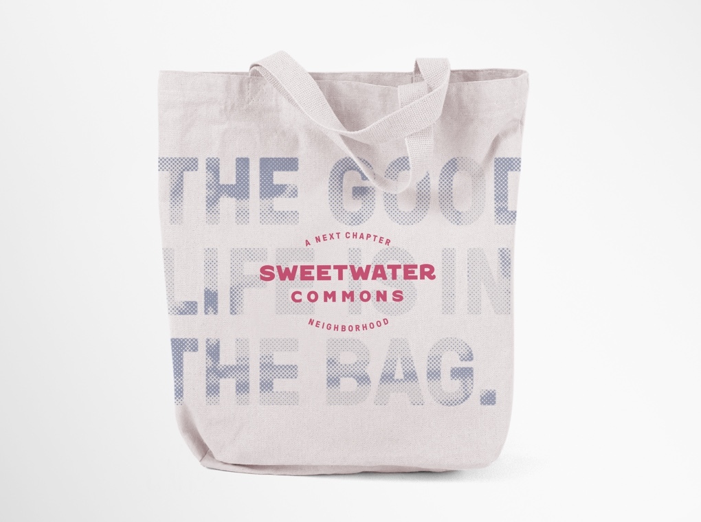 A Sweetwater Commons branded tote bag printed with phrase "The good life is in the bag."
