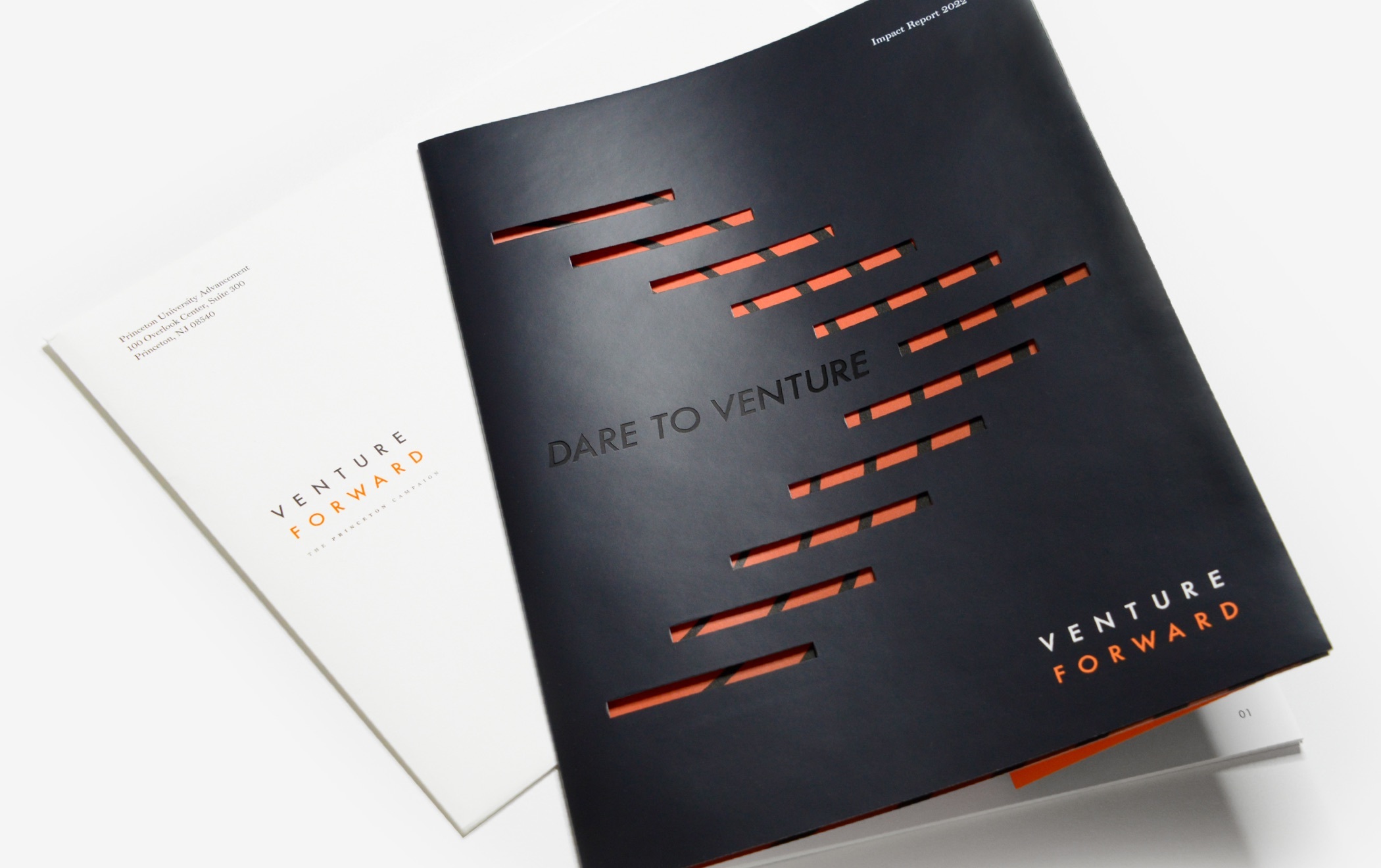 The front and back of the Princeton Venture Forward campaign brochure. The front is black with cut outs in the shape of a chevron revealing an orange page underneath. The center reads “Dare to Venture” and the bottom right corner reads “Venture Forward.” The back of the brochure is white with gray and orange text that reads “Venture Forward.”
