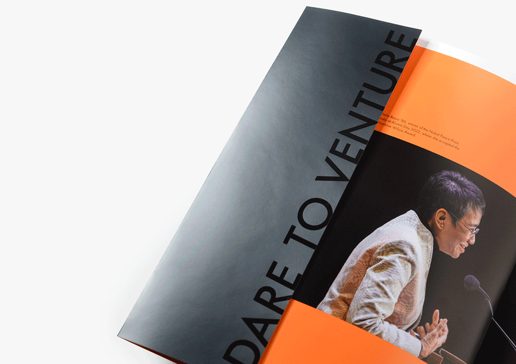 A close up detail photo of the design components from the brochure. Photo shows the inside front cover of the report, which features a photo of an asian man speaking at a podium microphone and a black, glossy flap that reads “Dare to Venture.” The image shows the flap opening up to reveal the table of contents.
