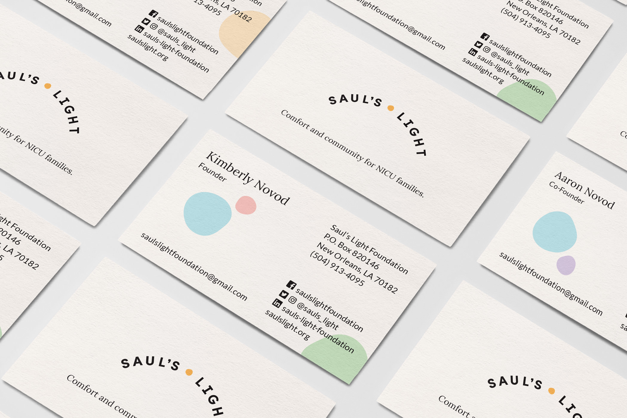 Several Saul's Light Foundation business cards, with the sun-dot logo and the text, Comfort and community for NICU families.