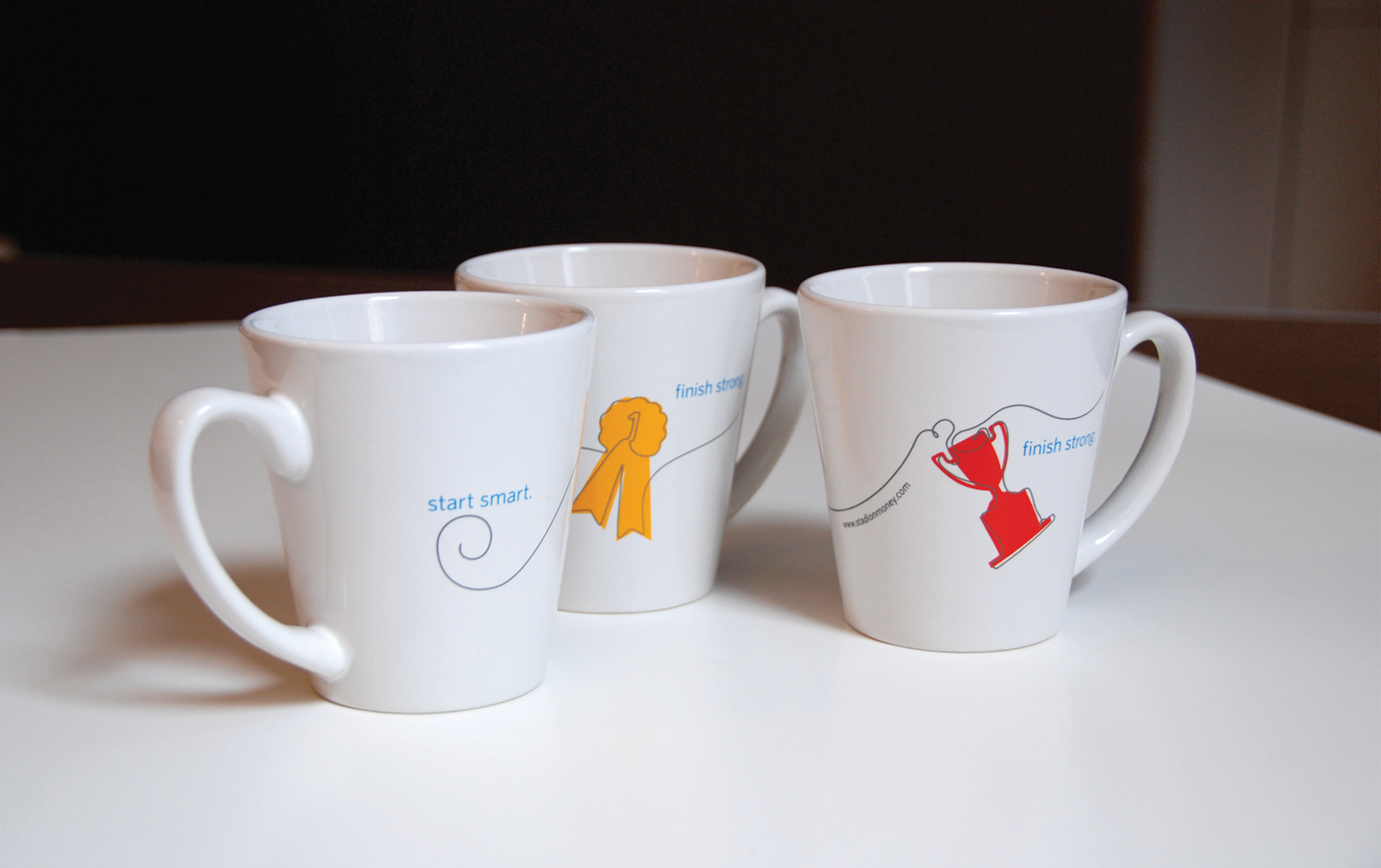 Stadion-branded coffee cups with brand illustrations and the tagline, "Start smart, finish strong."