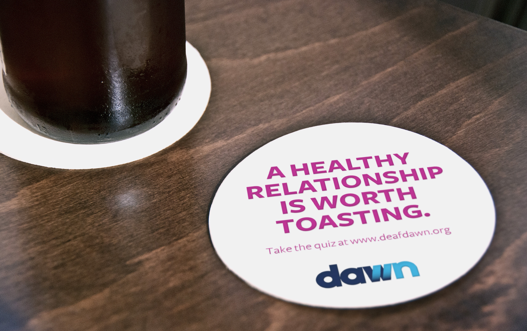 A Dawn-branded dring coaster with the text, A healthy relationship is worth toasting.