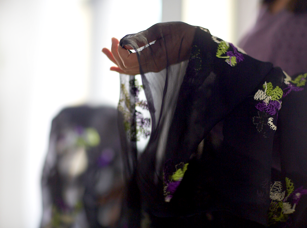 An example of Think Responsive brand photography: side view of an upturned hand in the sleeve of a purple patterned garment.