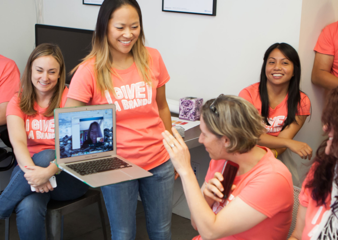 Thinkso staff in matching pink T shirts enjoy a light moment during the Give A Brand design sprint.