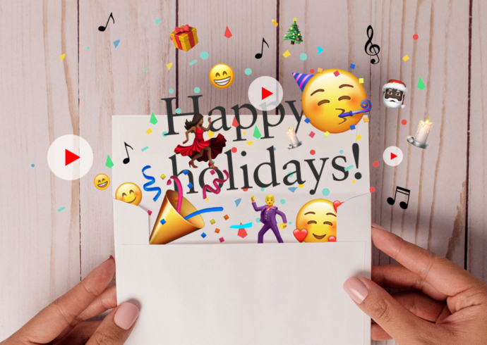 Hands holding an envelope with a holiday card and confetti, musical notes, and happy emojis coming out of it.