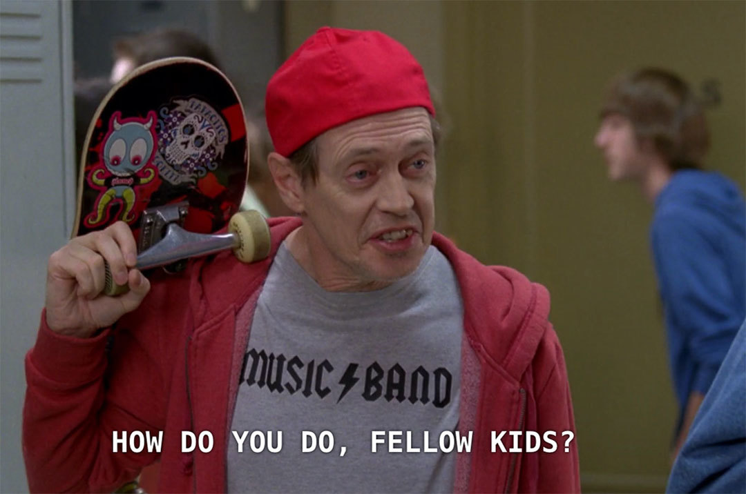 Still frame from TV show 30 Rock of Steve Buscemi in a high school hallway, with caption "how do you do, fellow kids?" 